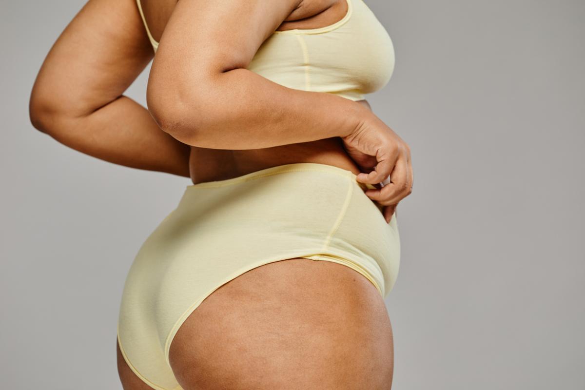 Photo of a curvy woman in a yellow bikini.